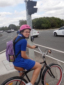Girl riding to school on a cruiser bike